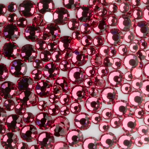 A large number of pink, shiny, round rhinestones or sequins cover the surface, creating a glittery effect.