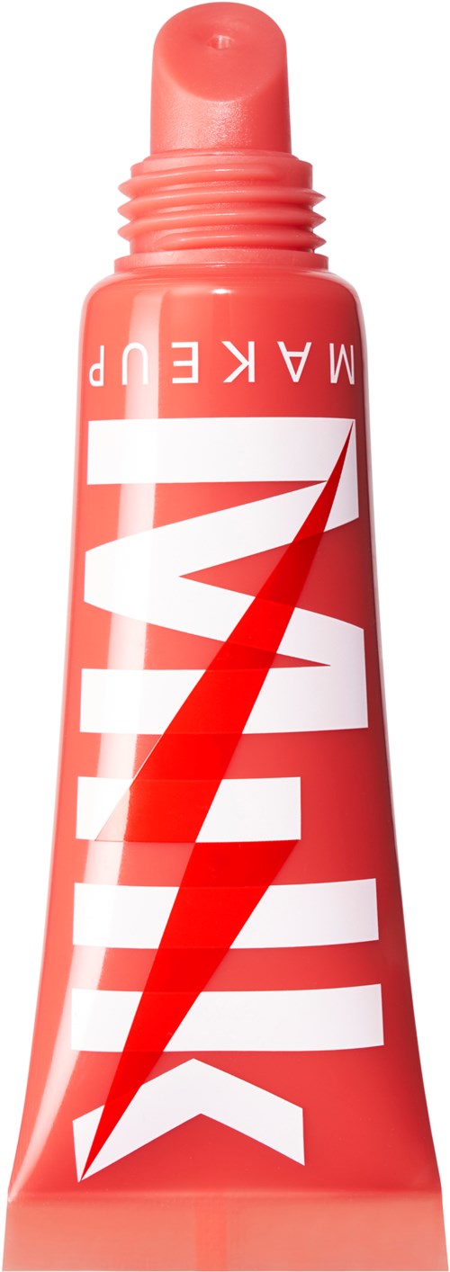 A coral-colored tube with a red lightning bolt and white text, likely a skincare or cosmetic product.