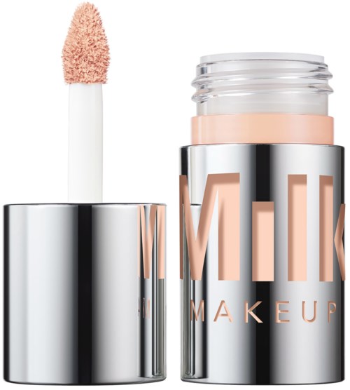 A shiny makeup stick with beige color, with the cap open showing the applicator sponge.