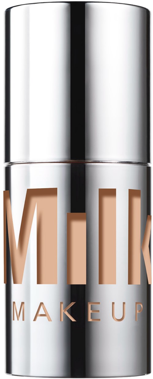 A silver bottle with the words 'MILK MAKEUP' written on it in brown letters.
