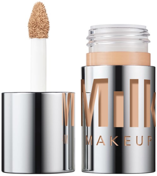 Lip or concealer product with applicator and shiny silver packaging.