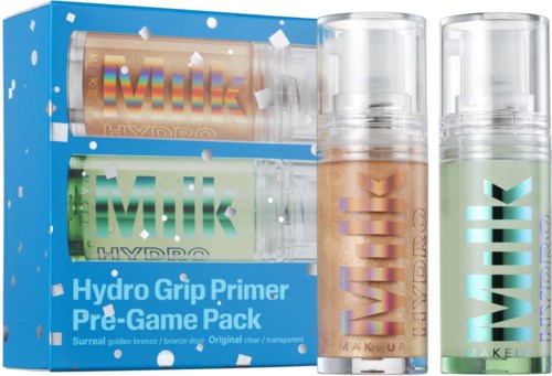 Two tubes of primer and a cardboard box display makeup products, including a bronze-colored and a clear one.