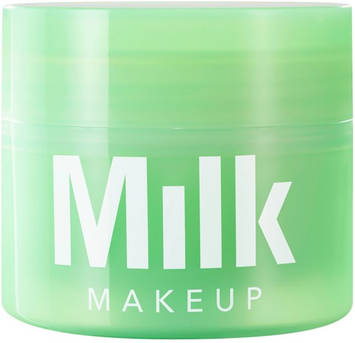 Ein runder grüner Behälter mit weißen Text, der sagt "Milk Makeup."