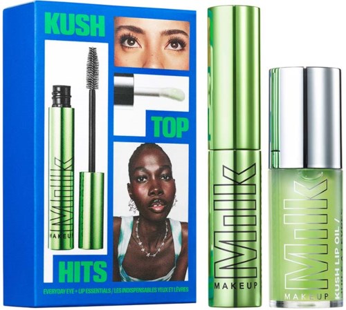 Lippenolie en mascara naast een kleurrijke advertentie voor Kush Top. De advertentie toont twee vrouwen met verschillende ooglooks.