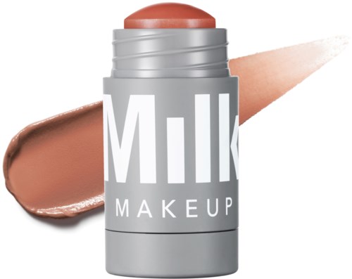 Een grijze container met 'Milk Makeup' erop, met een perzikkleurig product boven en een smudge erachter.