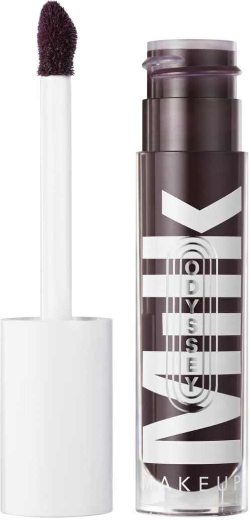 A lip gloss tube with a white applicator wand, mostly black and white label with large text.