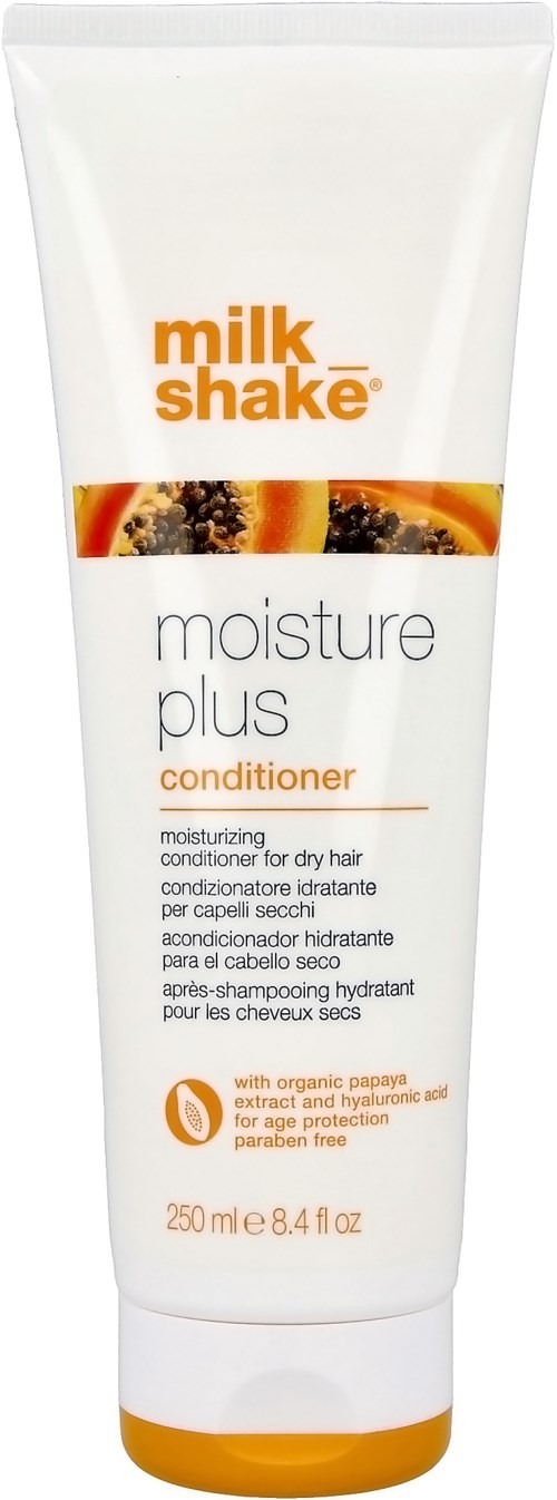 Een witte tube met 'milk shake' en 'moisture plus conditioner' met oranje accenten, bevat haarconditioner.