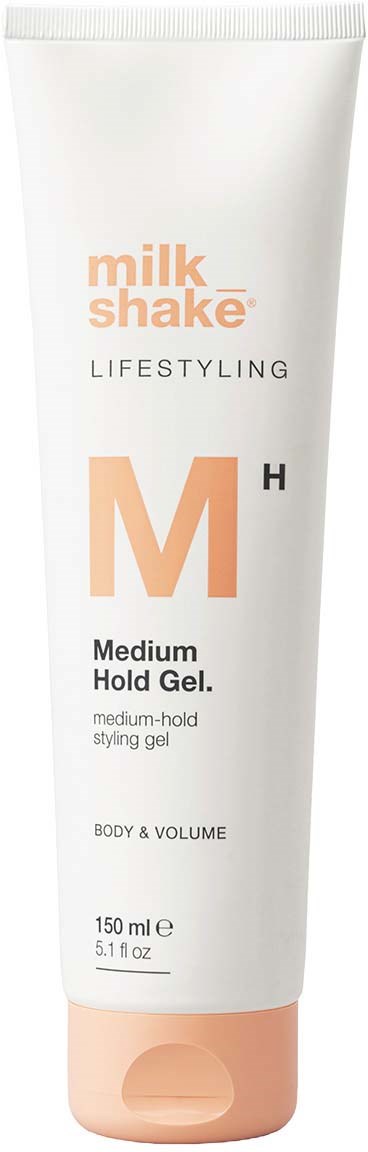 Een witte tube met een perzikkleurige dop, gelabeld 'milk shake LIFESTYLING Medium Hold Gel, 150 ml.'