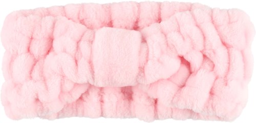 A pink fluffy headband with a bow in the middle, made of soft fabric.
