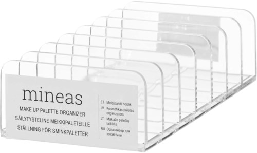 Plastic organizers with labels for makeup palettes in several languages, arranged in a row.