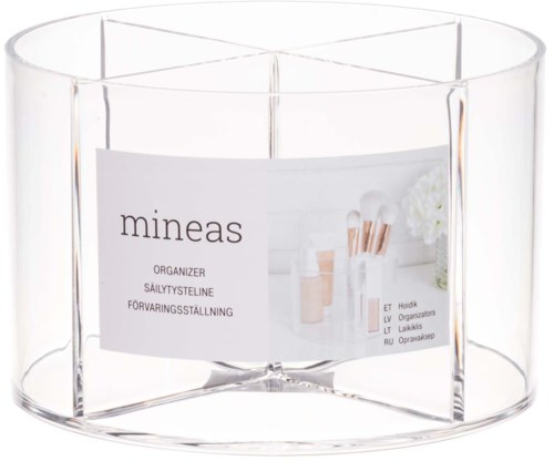 Clear round container with a label that says 'mineas' and shows makeup brushes and a white flower.