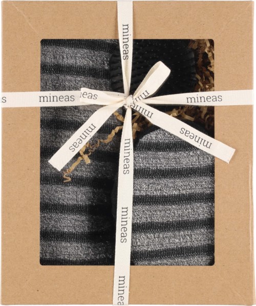 A gift box with a black and brown item inside, wrapped with a white ribbon labeled 'mineas' and a bow.