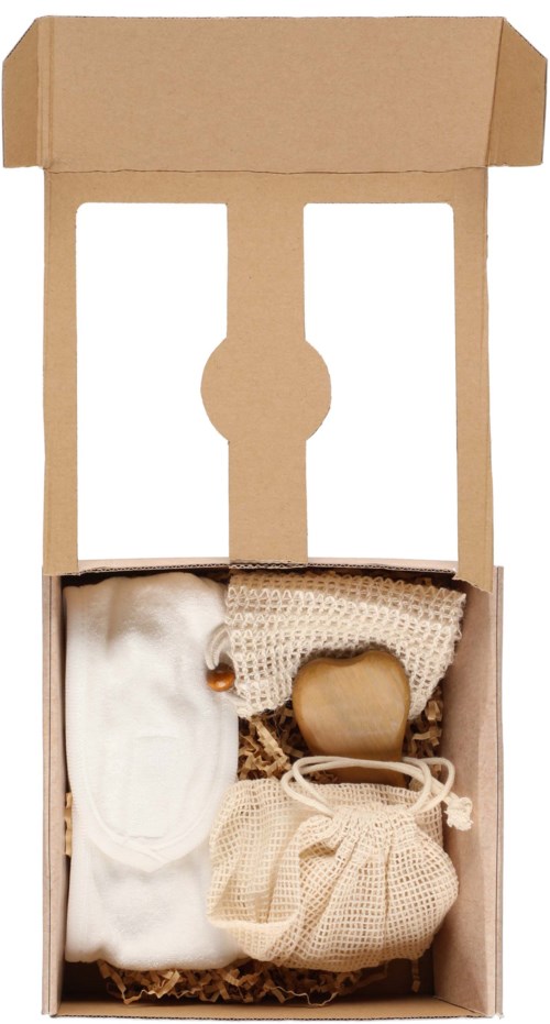 A cardboard box contains small fabric items, including a white cloth, a beige item, and two small wrapped packages.
