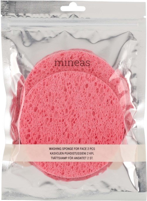 Two pink washing sponges in clear plastic packaging. The package has a brand name 'mineas' and contains two face sponges.
