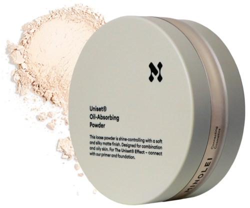 En rund behållare med oljefrånvändande puder och en beige lös produkt som spillts bredvid.