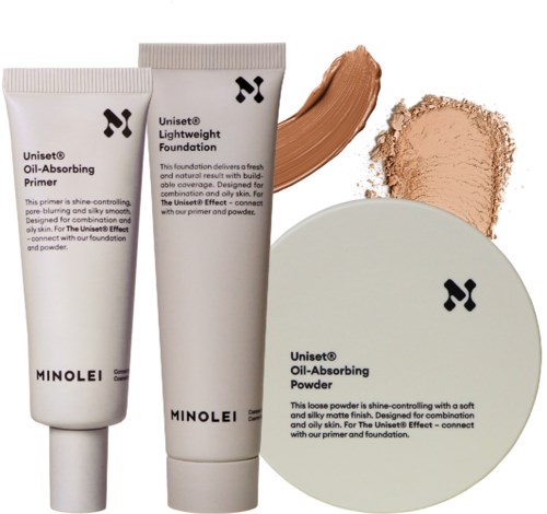 Tre makeup-produkter: primer, foundation och puder i vita tuber och ett runt fall, alla med svart logga.