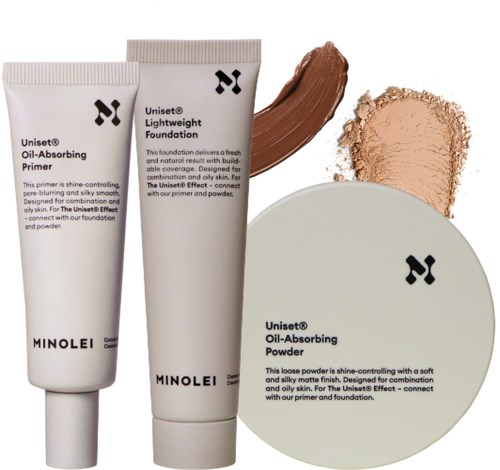 Tre makeup-produkter: primer, foundation och puder, alla i vita förpackningar med svart text och logga.