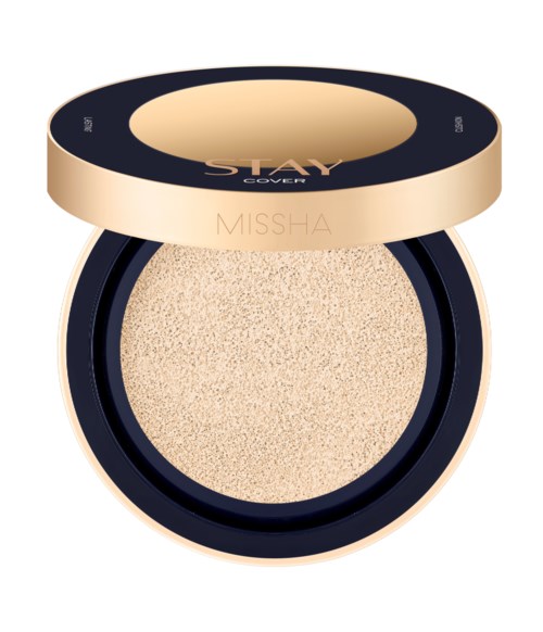 A round beauty sponge inside a black and gold compact with the words "Stay Cover" and "Missha" on the lid.