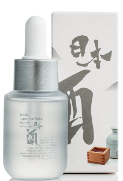 Klein glazen fles met witte druppelkap en Japanse tekens op het label, naast een doos en klein potje.