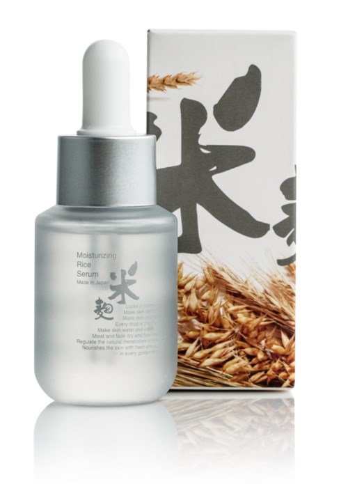 Een zilveren fles met druppelkopp, naast een doos met rijst en Japanse karakters.