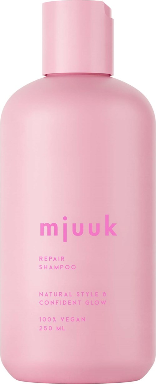 Roze fles met deksel, gemarkeerd Mjuuk Repair Shampoo, vegan en natuurlijke ingrediënten, 250 ml.