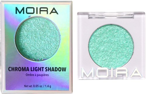 An iridescent eyeshadow in a clear case next to holographic packaging, labeled 'MOIRA Chroma Light Shadow.'