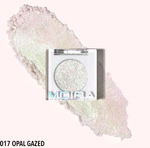 A small, square eyeshadow palette with a shimmer eyeshadow called 'OPAL GAZED' and 'MOIRA' logo, on a sparkly background.