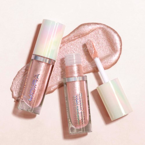 Three lip gloss bottles with pink shimmer, one with applicator, on a white surface with smeared gloss.