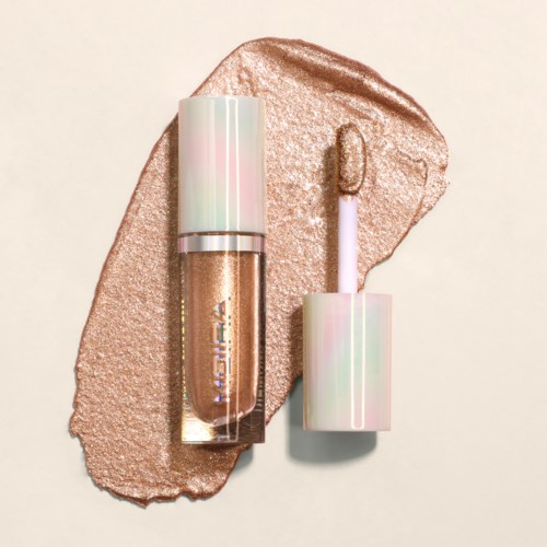 A shimmering gold makeup sample with a shiny, pastel-colored cap and an applicator wand.