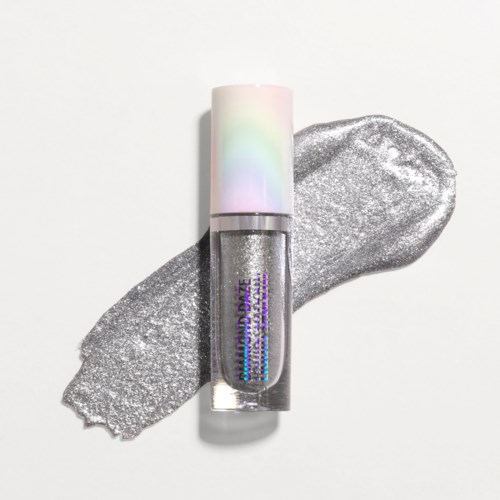 A silver glitter nail polish bottle with a pastel cap, placed on a silver paint streak.