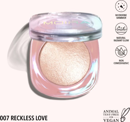 A compact makeup product with a shimmering, glowing surface inside a clear container, labeled 'Reckless Love'.