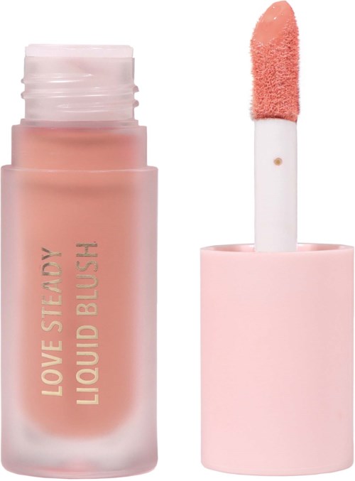 A pink liquid blush in a glass tube with a sponge applicator. The label says "Love Steady Liquid Blush."