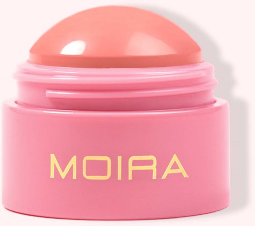 A round, pink container with a matching lid, labeled 'MOIRA.' It looks like a cosmetic or skincare product.