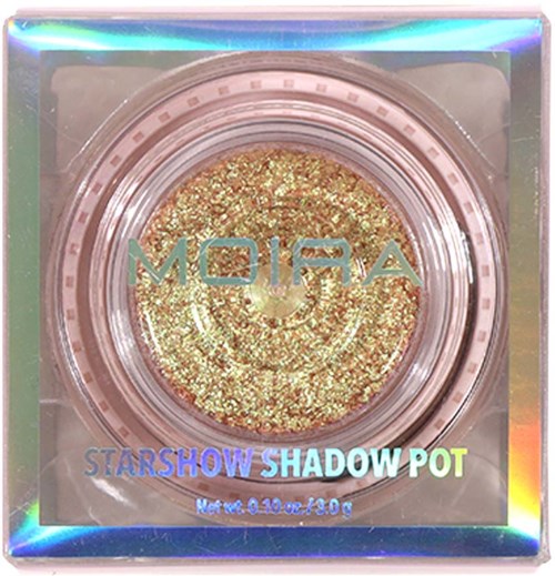 Glitzernder goldener Lidschatten in einer runden Dose. Verpackung ist glänzend und farbenfroh mit Worten wie 'Starshow Shadow Pot.'