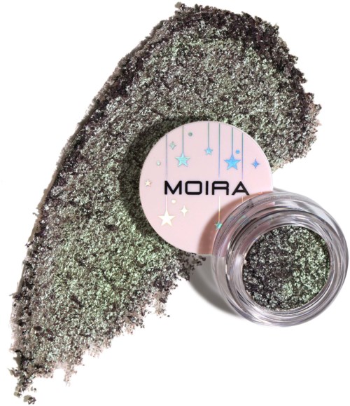 A jar of sparkly loose glitter with a label that says 'Moira'. The glitter is spread next to the jar.