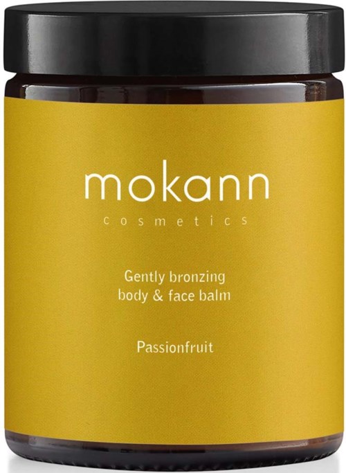 Ein gelber Behälter von Mokann Kosmetik mit schwarzem Deckel, gekennzeichnet als Körper- und Gesichtsbalsam mit Passionsfrucht.