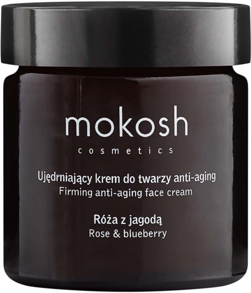 Een donkergekleurde pot met een zwart deksel, met het label 'mokosh cosmetics' en informatie over een anti-verouderings gezichtscrème met roos en blauwe bes.