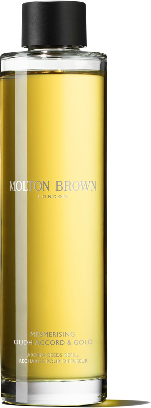 Eine lange Glasflasche mit einem schwarzen Deckel und gelber Flüssigkeit, beschriftet 'Molton Brown London'.