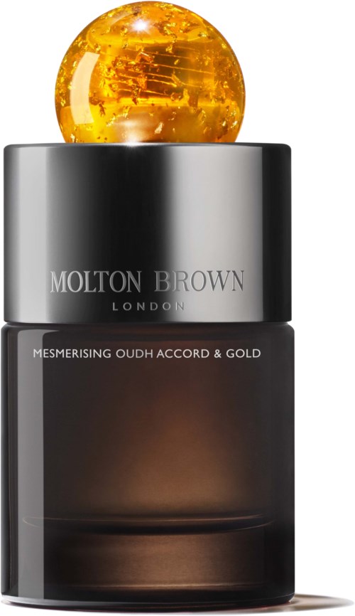 Eine schwarze Flasche mit Silberkappe und einer goldenen Kugel oben, beschriftet Molton Brown London, mit goldfarbenem Text.
