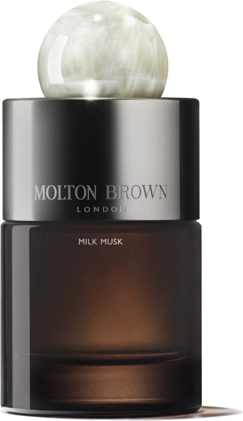 Ein dunkle Parfümflasche mit silberner Kappe und einer runden, hellfarbenen Kugel auf der Oberseite. Das Etikett sagt 'Molton Brown London' und 'Milk Musk.'