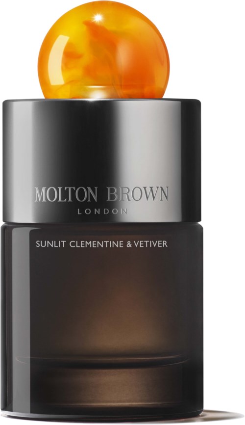 Eine Molton Brown London Parfümflasche mit orangefarbem Kugeldeckel und schwarzem Körper.