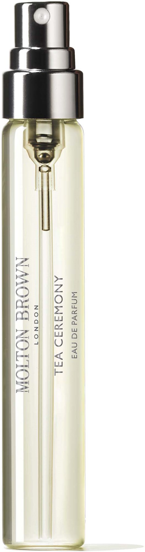 Kleine Parfümzerstäuberflasche mit silberner Spitze und klarem Körper, beschriftet 'Motion Brown Tea Ceremony Eau de Parfum.'