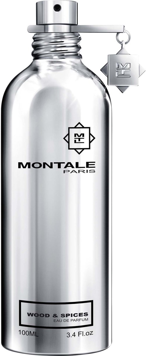 A tall, clear glass perfume bottle with a silver top and label for Montale Paris, Wood & Spices scent.