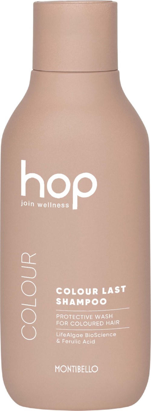 Beige shampoo- pullo, jossa lukee 'hop join wellness' ja 'Colour Last Shampoo'. Se on värjätylle hiuksille suojivatehosta.