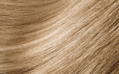 A close-up of light brown, straight, and shiny hair strands.