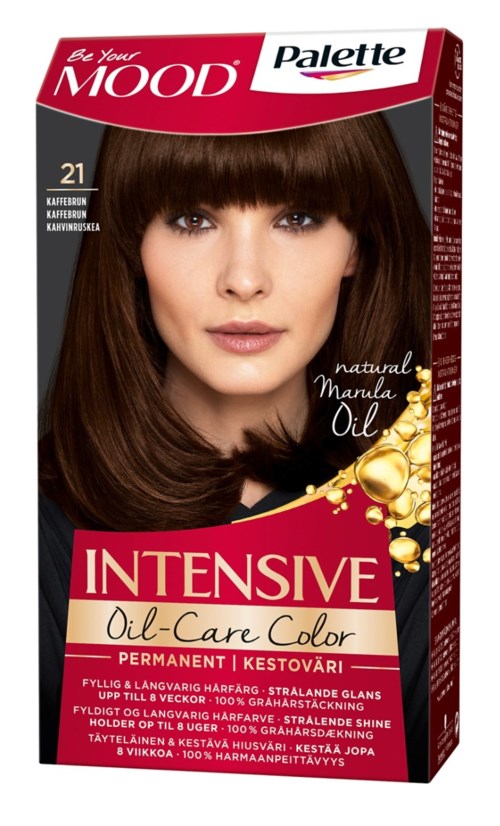 Een vrouw met lang bruin haar en bangs op een haarverfpakkingsdoos. De doos is rood en wit met tekst en gouden accenten.