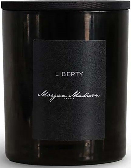 A black candle jar with a label reading 'Liberty' and 'Megan Madison' in script.