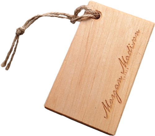 A wooden tag with a string, engraved with the brand name 'Megan Melvin'.