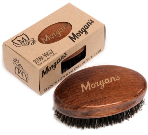 A wooden grooming brush with black bristles in front of a brown box labeled 'Morgans' and 'Brenard Brush'.