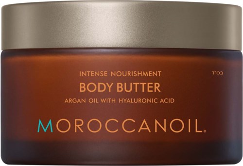 En brun krukke med body butter med gullokk, merket Moroccanoil, med arganolje og hyaluronsyre.
